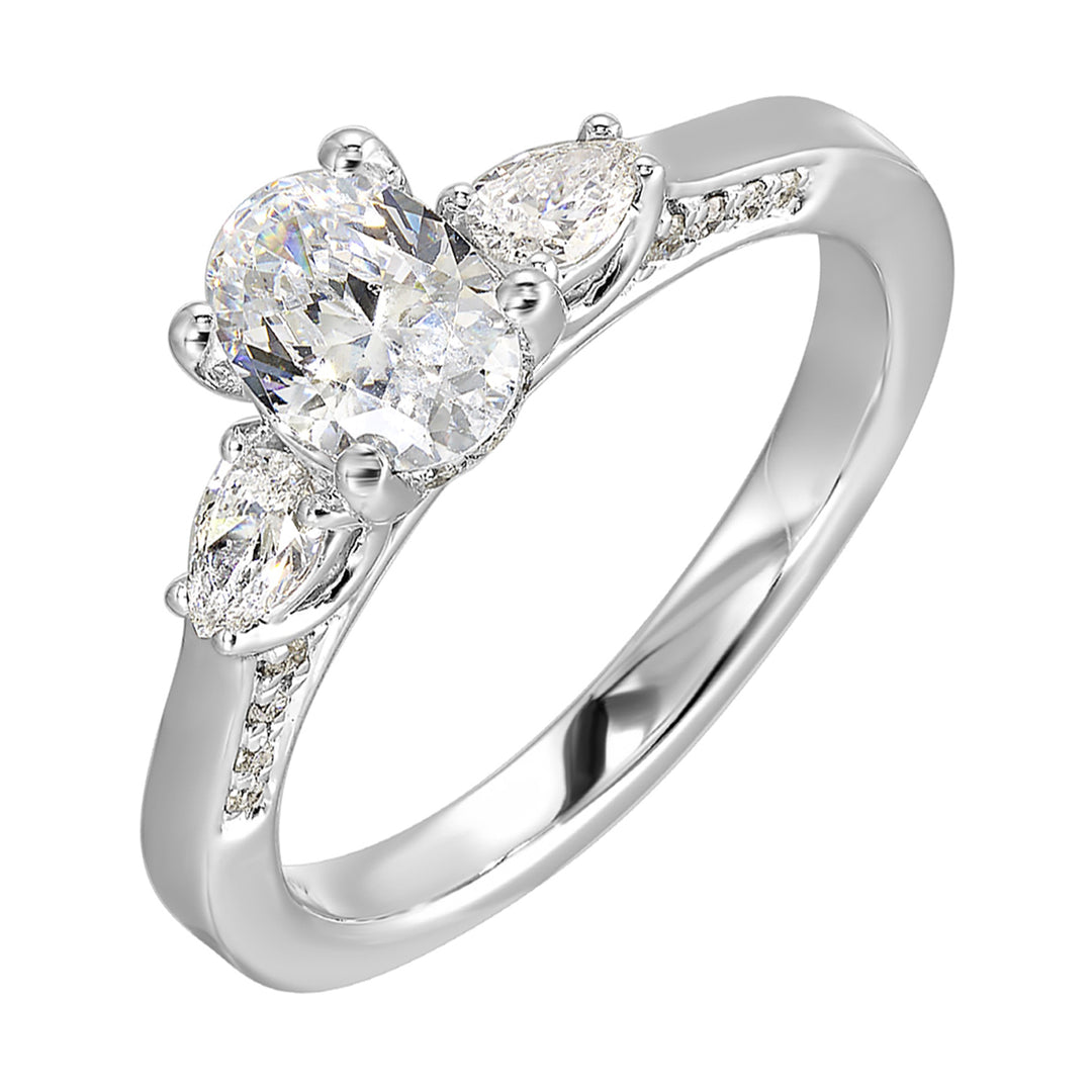 Three stone ring features an oval cut solitare nestled inbetween pear cut diamond, all embellished with sparkling diamond accents in front.