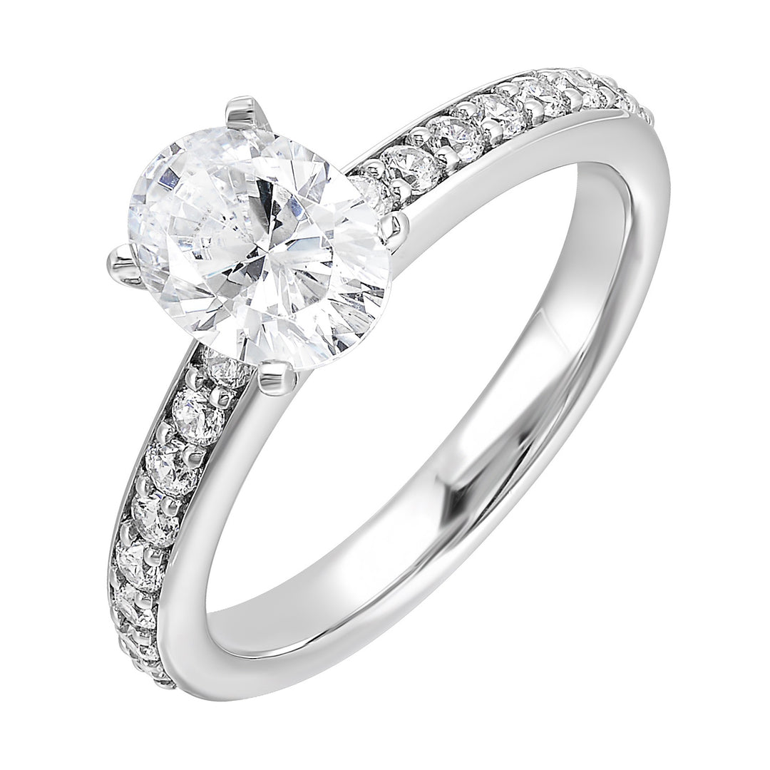 Sleek and beautiful, this diamond engagement ring set with pave diamonds complements the oval solitare.