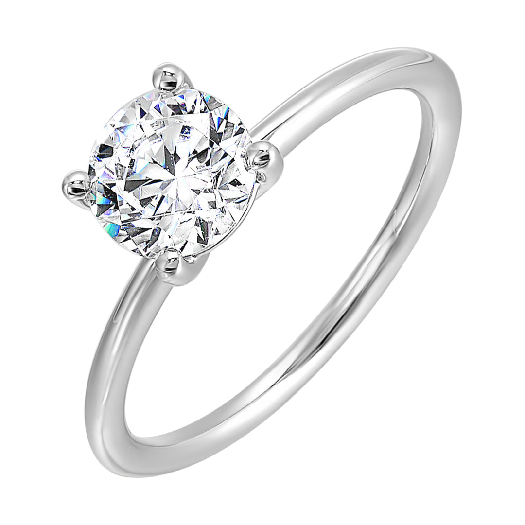 Classic four prong solitaire engagement ring with a petite band adds to the sleek, classic look of the design.