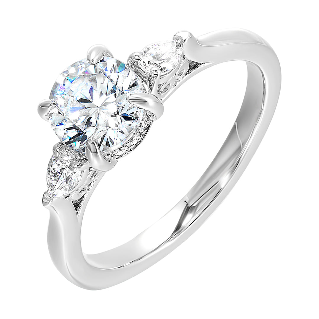 Captivating pear shaped diamonds frame the center solitare in this classic three stone ring with hidden diamond accent in front.